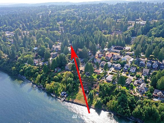 Aerial view of the lower portion of Suquamish (Angeline to Augusta primarily) and its proximity to the waterfront.  The location of the Subject property is identified by the red arrow