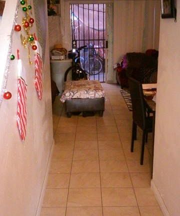 Front entrance, upstairs to the left and 1/2  bathroom to the right.  Living room, kitchen and patio straight ahead.