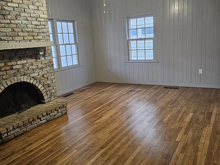 Living room with black steel back door to left of fireplace