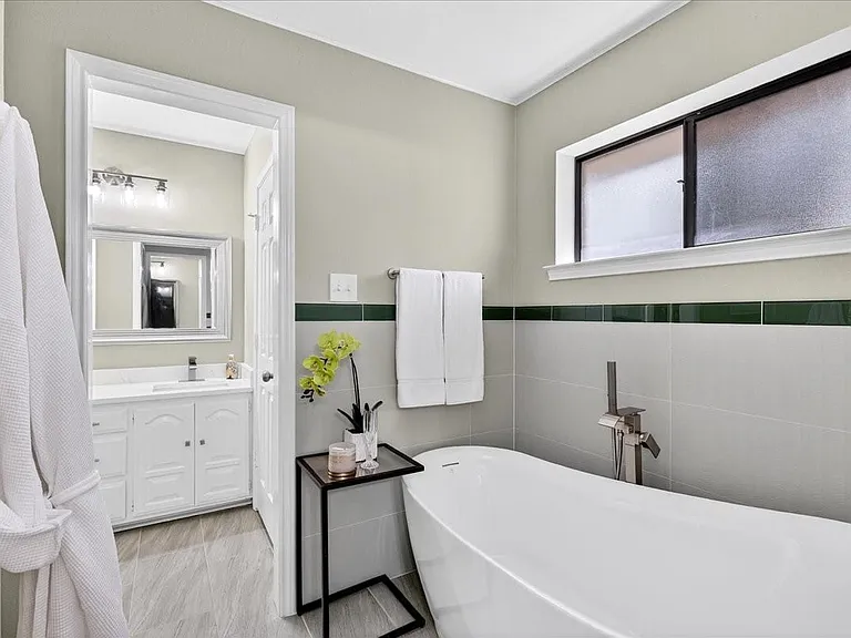 Bathroom Vanity with make-up area space and new quartz counters.