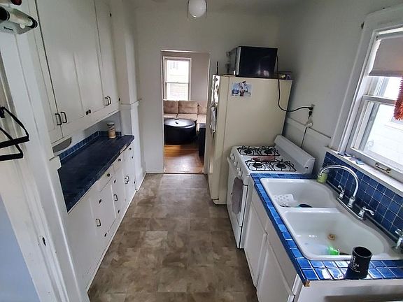 Kitchen has easy clean vinyl floor, lots of counter space, plenty of cupboards, large double sink, and large fridge.