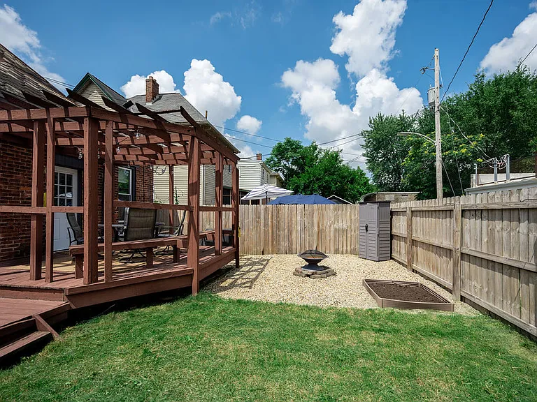 Fenced in backyard w/ deck