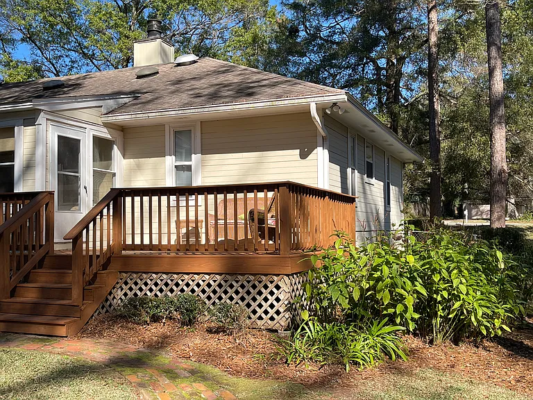 Private backyard with a large deck for socializing and relaxing.