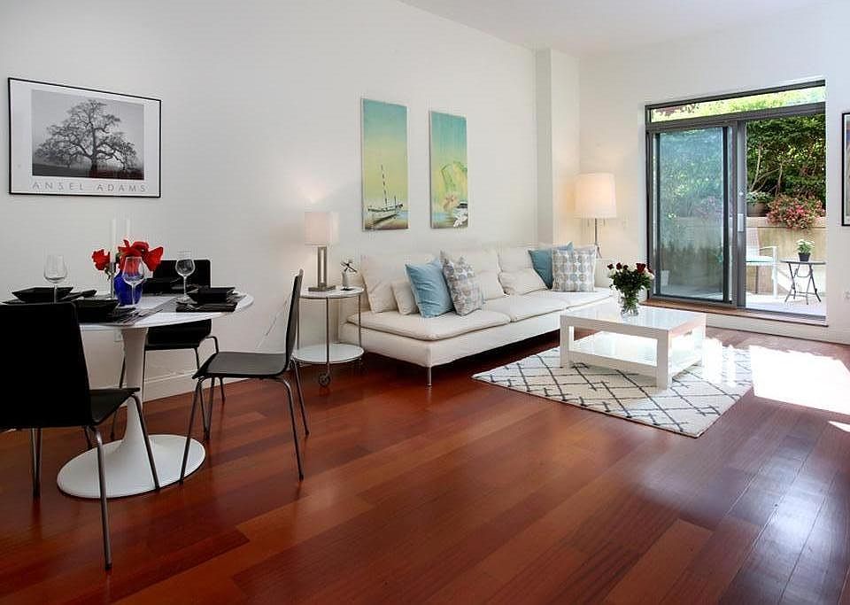 Living room area now includes 2 piece sectional, recliner, a dining table, large tv on stand, and 2 side tables