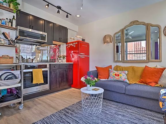Kitchen/living area. High end appliances including induction cooktop, granite counter.
