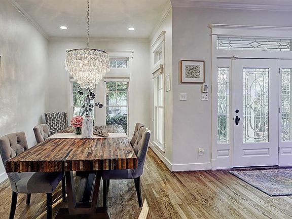 The formal dining room at the front of the home, located off the main foyer, has an abundance of windows as well as transoms making this house feel classic and modern at the same time. Another fabulous crystal chandelier!