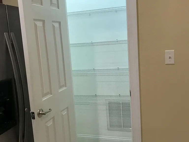 Wide pantry in kitchen. It goes another 3 feet to the left of door opening.