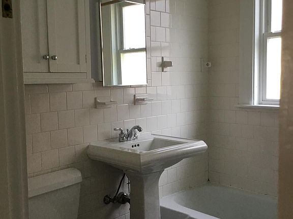 Bathroom, with a large built in floor to ceiling linen closet outside the bathroom