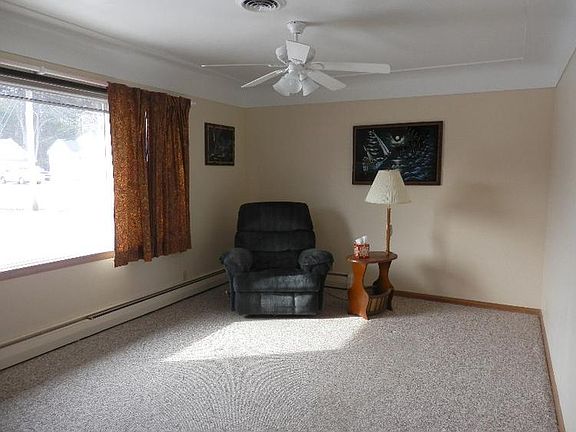 Spacious clean living room with lighted ceiling fan