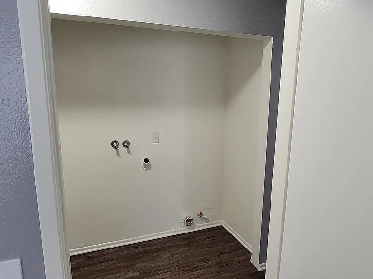 Washer/dryer hookups in hallway at Grand Oaks Apartments in Lake Elsinore, California.