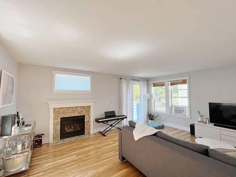 Gas fireplace; sun-drenched balcony offering privacy behind established hedge