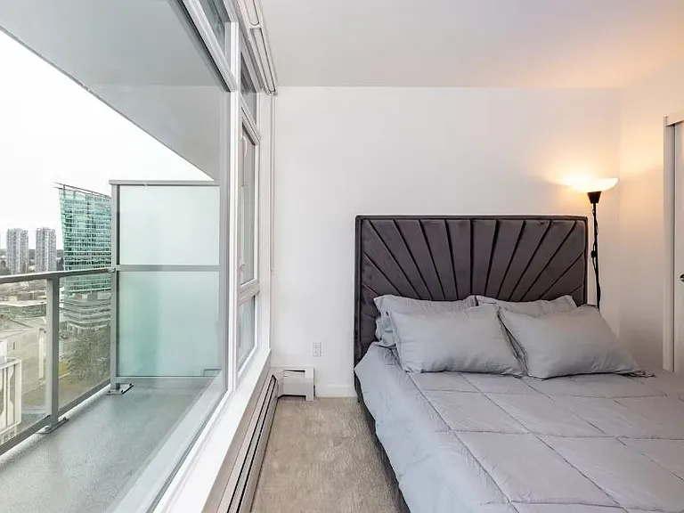 Large windows offering breathtaking city views, perfect for waking up to the skyline or enjoying the twinkling lights at night.