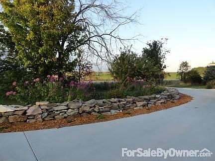 view of living room from entryway
						:
						acacia wood flooring with wood burning fireplace