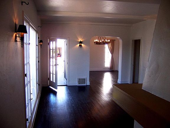 Huge living room with lots of natural light and gorgeous hardwood floors.