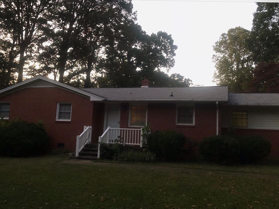 Front of house. Mature Muscadine grape vines.