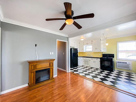 Enter the home into an open living space. There is room for a 4 seater table and chairs in the kitchen part of the area.
