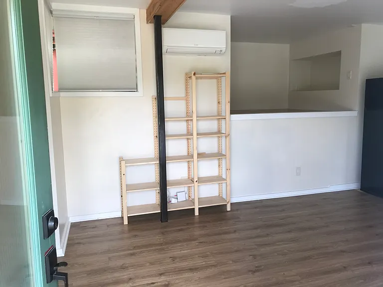 bedloft on south side of apartment with recessed nook with electrical plug