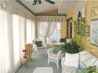 Sunroom looks out over inground pool & patio