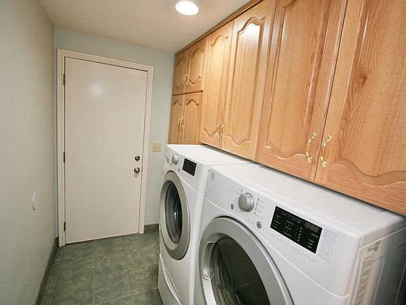 Laundry adjacent to kitchen with door to garage