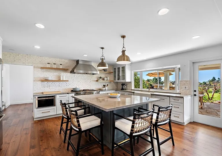 Gourmet kitchen with quartzite countertops, Italian ILVE range, spacious refridgerator and a large island.