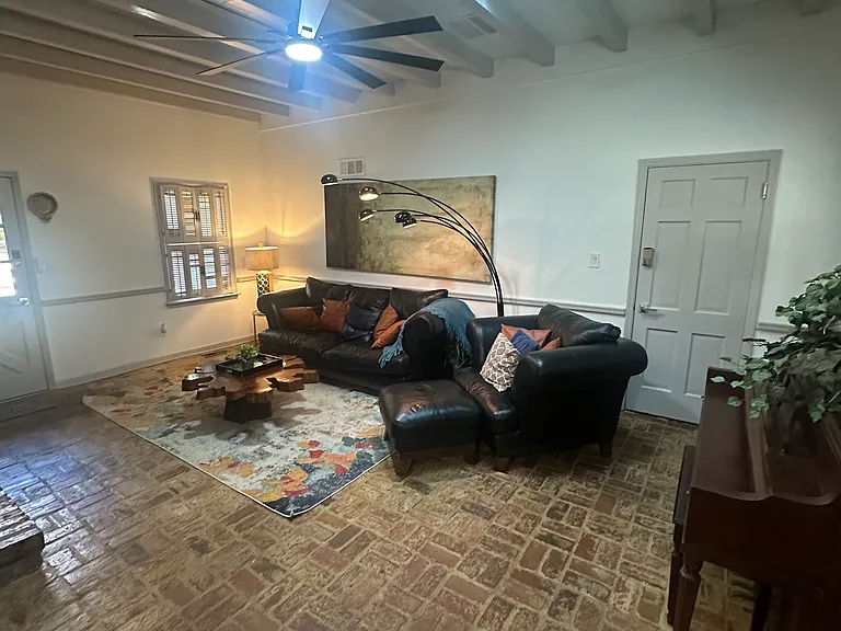 Brick walls, brick floors, big screen _ a space built for comfort and character.