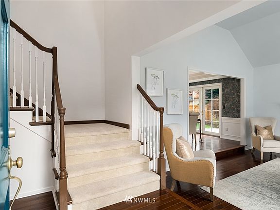 Gracious entry with a soaring ceiling opens to the formal living room.