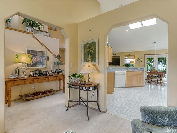 View from formal living room and into the main entry hall and kitchen.