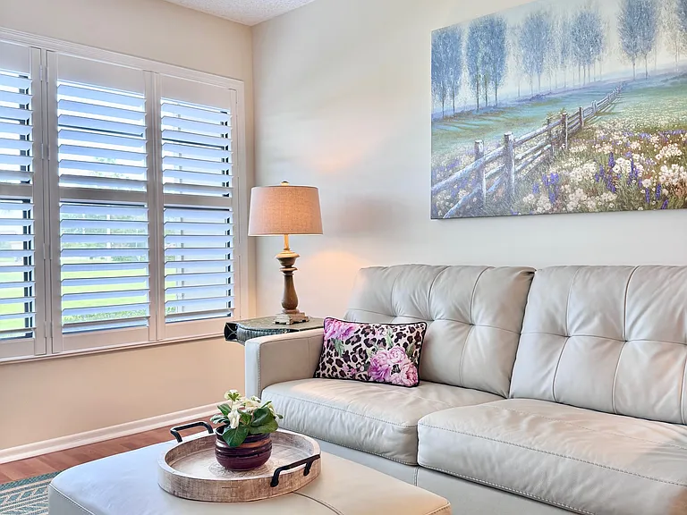Beautiful living area w/ plantation shutters & gorgeous lake & golf course views!