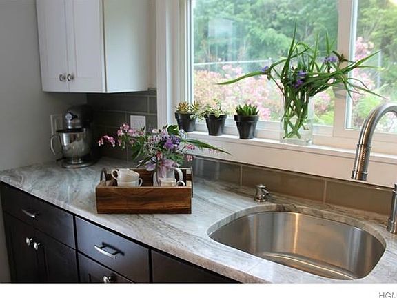 Brand new kitchen with solid wood cabinets, quartzite countertop, stainless steel appliances.