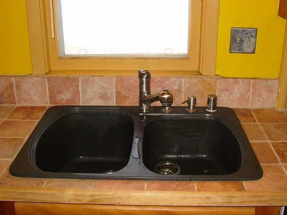 granite sink, travertine counter
