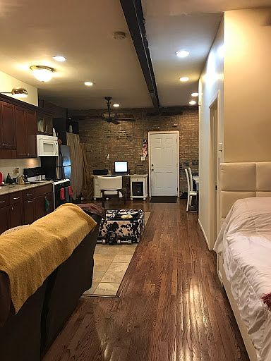 View from interior entrance door towards rear of Studio apartment unit.