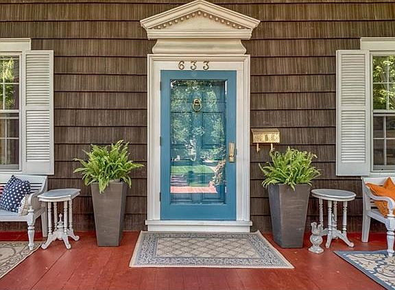 The welcoming front door with pointed pediment and dentil work detailing