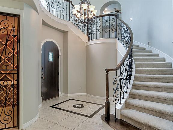 The wine "cellar", metal front door, and the spiral staircase set the scene for this elegant home.