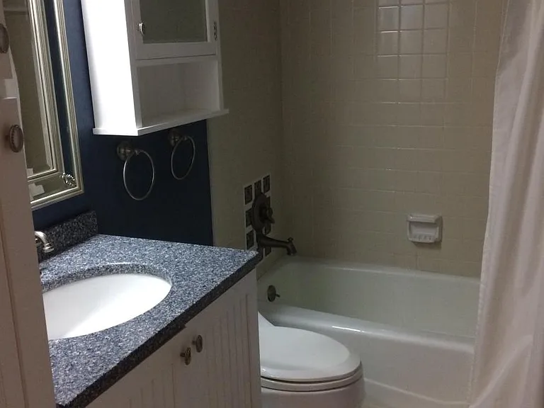 Nice bath with plenty of storage, tiled encased tub and floo