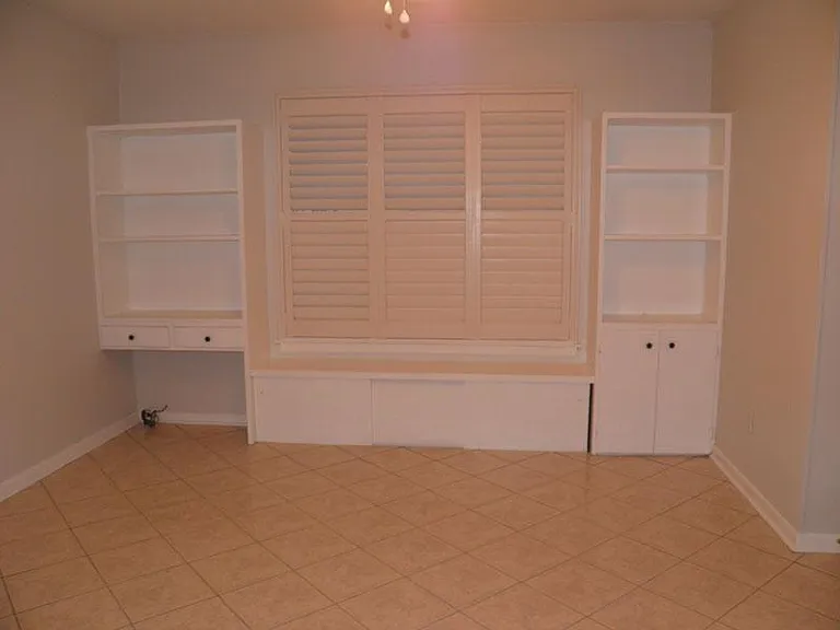 Kitchen eat in area with plenty of storage. Plantation shutters allow light to filter into the kitchen.