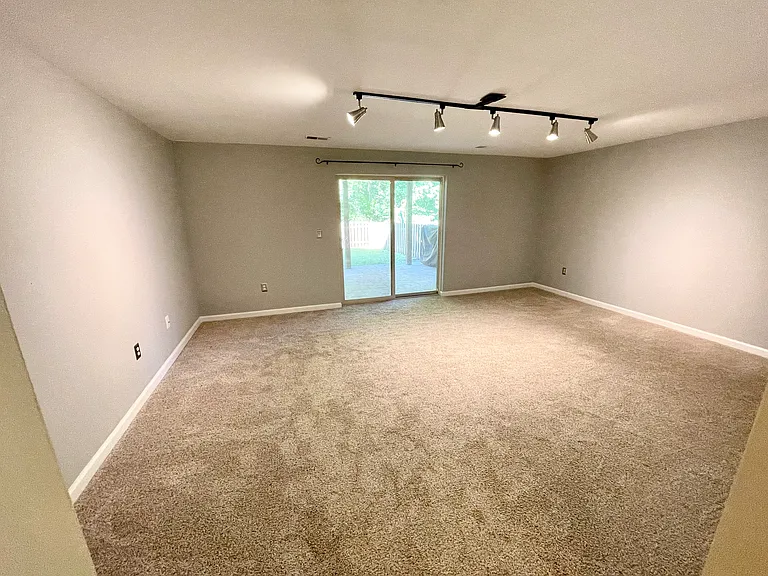 Large open basement with unfinished storage/laundry room and half bath