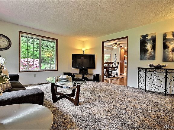 This is a wonderful, social room featuring the kitchen,  dining space and there is a wood  stove for that added warmth on a cold winter night.