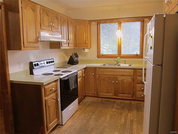 The updated Kitchen features LOTS of maple cabinetry, miles of counterspace, and newer appliances.  The decor is light & bright - as is the new LED pendant light fixture over the double sink!
