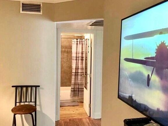 65" FLAT SCREEN WALL MOUNTED TV