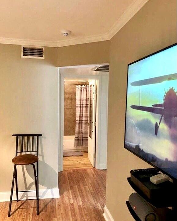 65" FLAT SCREEN WALL MOUNTED TV