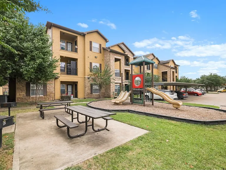 Playground with picnic area and grills at Stonehaven Apartments in Houston, TX