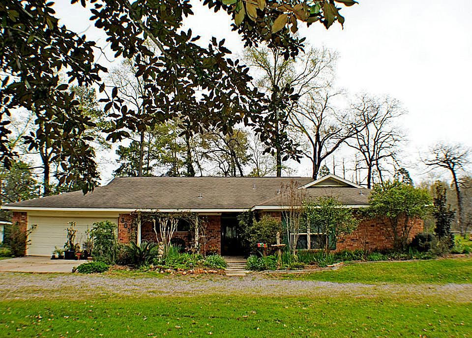 Lovely single story brick home on 5+ acres.