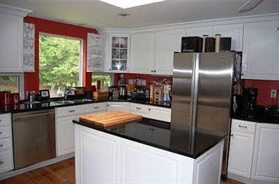 Kitchen w/stainless steel Jenn-Air appliances and granite counters