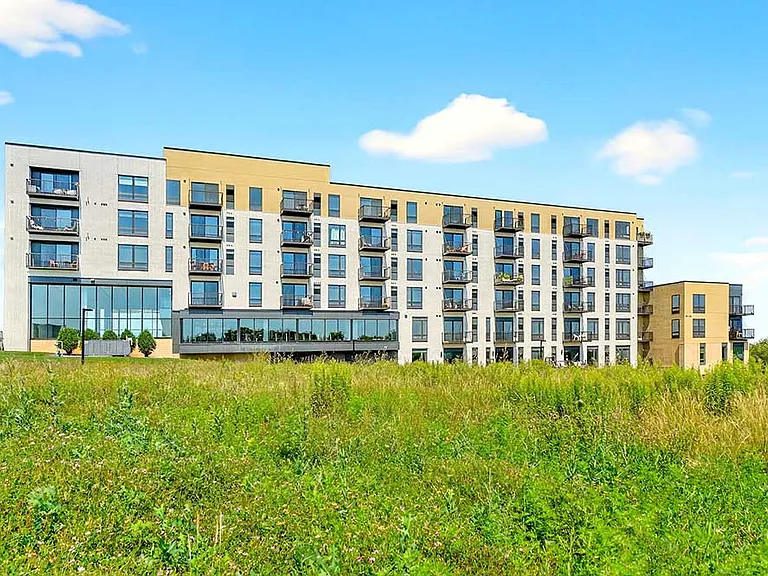 Modern residences set against open green space create a peaceful backdrop for everyday living.