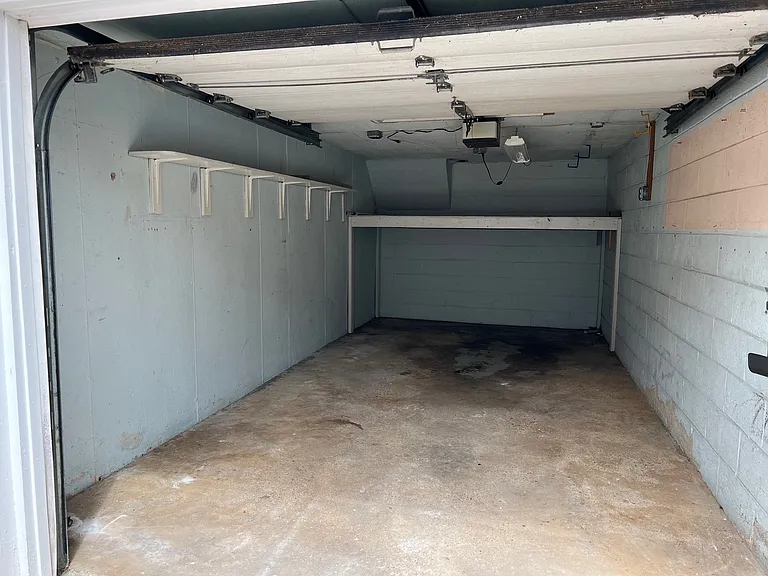 Garage - 1 Car with Shelf in back. Also has hose connection.