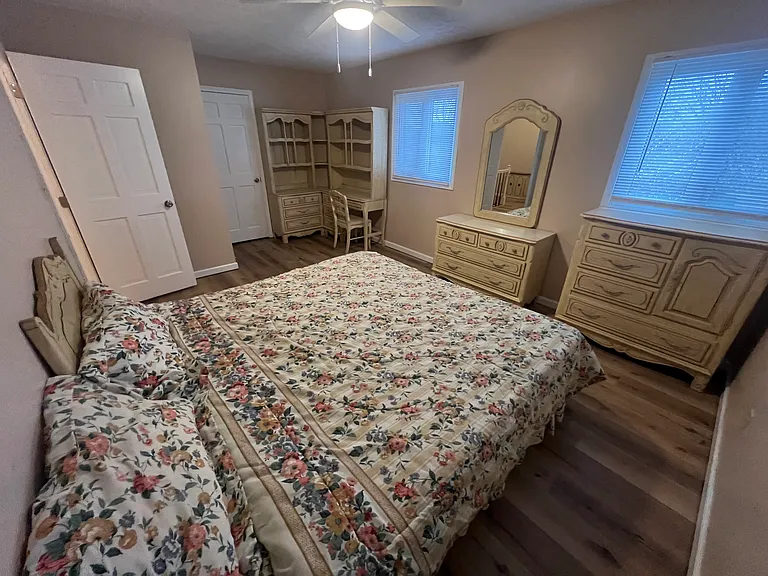 This is bedroom number three- one of the three non-master bedrooms upstairs furnished with a Queen bed 3 dressers, a desk/chair, 2 hutches and mirror set and it is a huge room! it has a walk-in closet as well as new LVP flooring! Fresh paint!