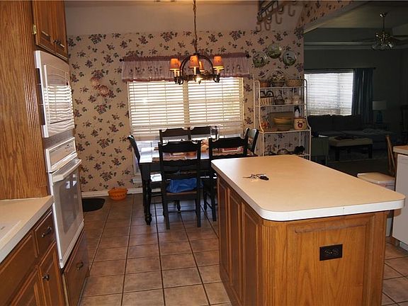 Large center island with kitchen dining and joining family room  with pantry area and tons of counter spacel
