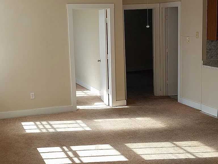 Spacious Living Room Leading to Two Bedrooms