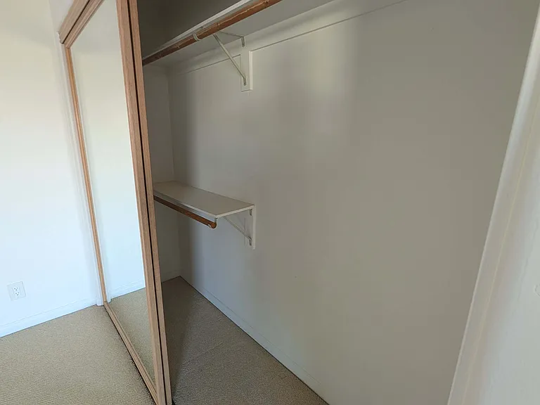 The large closet features ample space to hang clothing and easily fits a dresser or two inside.