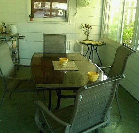 Four seasons room attached to garage makes for a great outdoor dining area!